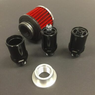 New engine crankcase breather adapters from XRP shown in three styles. From left to right:  1) Straight through tube only.  2) One-way pop off with fully adjustable engine vacuum control. 3) One-way pop off with normally fully closed check valve, non adjustable.  Black anodized aluminum.
All have a -12 male O-Ring boss thread and may use any commonly available 1-3/8″ crankcase filter. (Not included) Also shown is an aircraft style -12 female O-Ring boss weld-on port, 6061-T6 aluminum, with raised flange base that is designed to prevent thread and seal area distortion when welded. (Sold separately