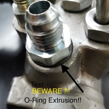 DO NOT DO THIS!! Here an XRP P/N 790586 Power Steering adapter, -6AN to 5/8”-18 Inverted Flare Seat, has been modified by another party to remove the designed Inverted Flare Seat Seal and an O-Ring was added to try and make it seal on the Female Port in a power steering rack.  This adapter does not have a HEX size large enough to fully cover and contain an O-Ring in the female port. The fluid pressure has pushed the O-Ring out, extruding it, and causing a dangerous power steering fluid leak. XRP does not approve of this modification or use of this adapter with an O-Ring. SWIPE Left for more